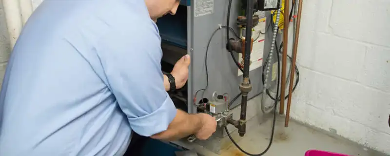 Furnace repair technician inspecting and servicing a home heating system in Seattle, WA