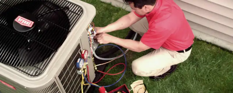 HVAC technician servicing an outdoor air conditioner unit in Seattle, WA